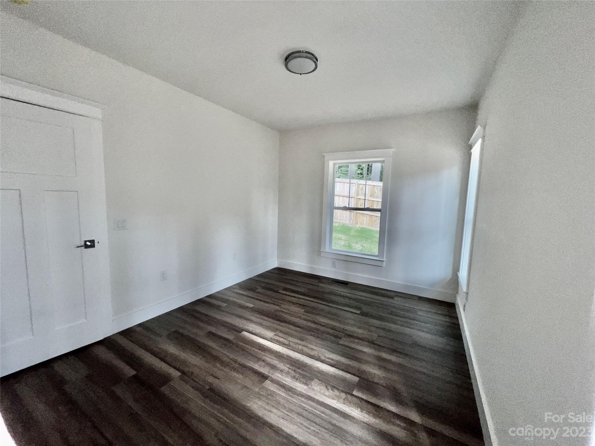 170 Cascade Rdg Road Fairview, NC 28730 - Photo 15 of 23 a view of an empty room with wooden floor and a window
