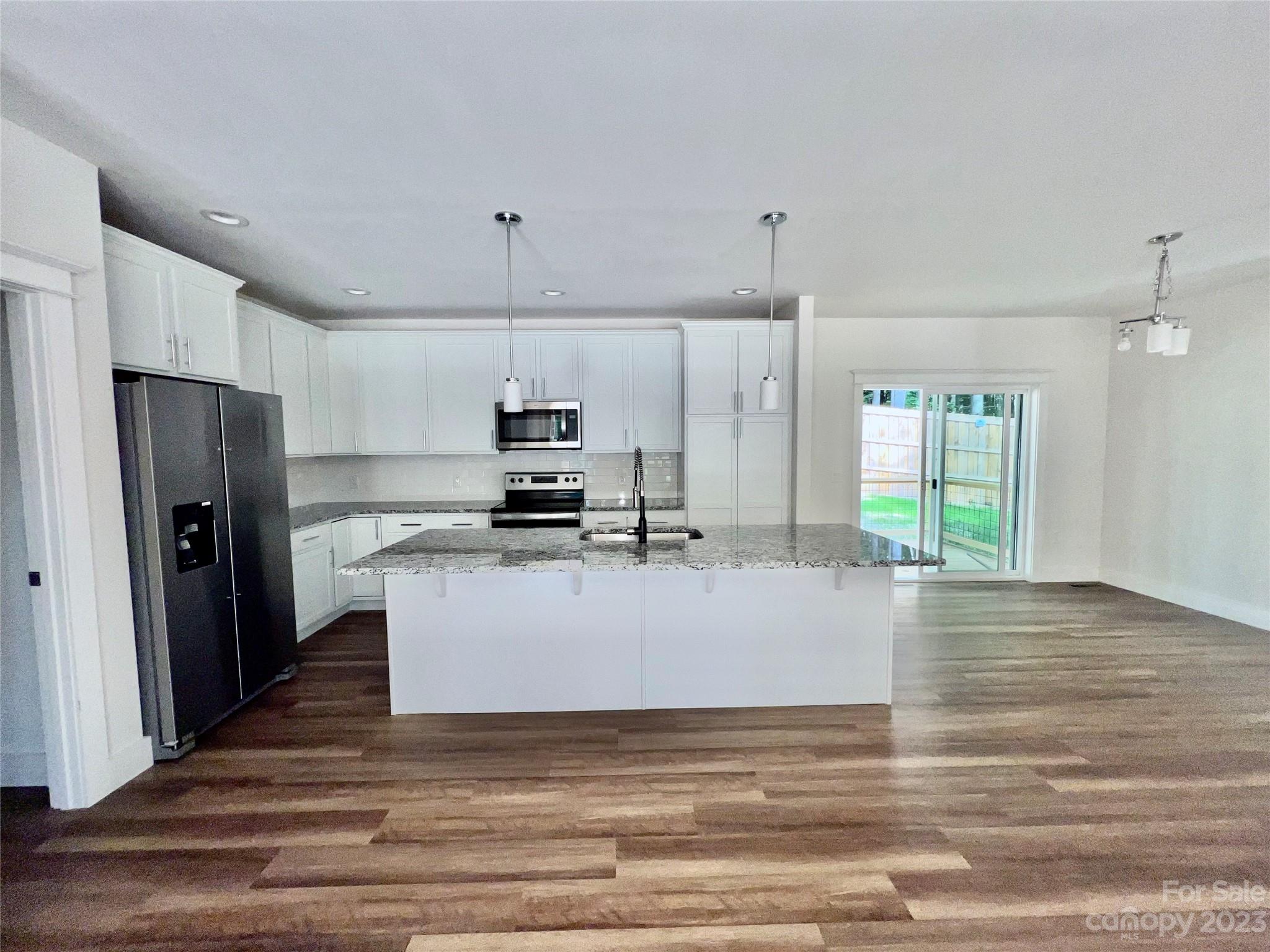 170 Cascade Rdg Road Fairview, NC 28730 - Photo 6 of 23 a view of kitchen with stainless steel appliances wooden floor and window