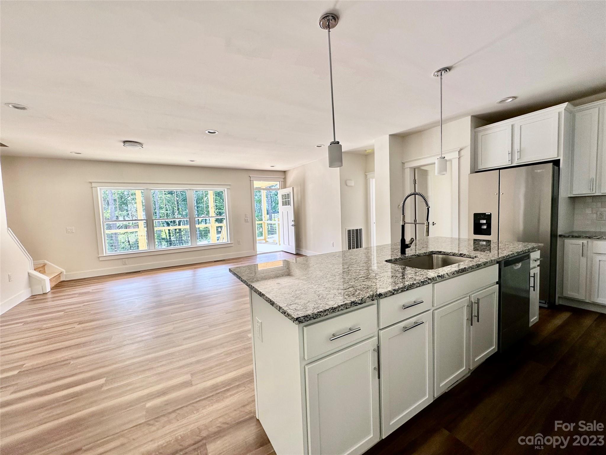 170 Cascade Rdg Road Fairview, NC 28730 - Photo 9 of 23 a kitchen with stainless steel appliances granite countertop a sink a stove a refrigerator and island with wooden floor