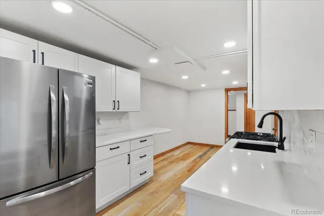 a kitchen with stainless steel appliances a refrigerator sink and stove