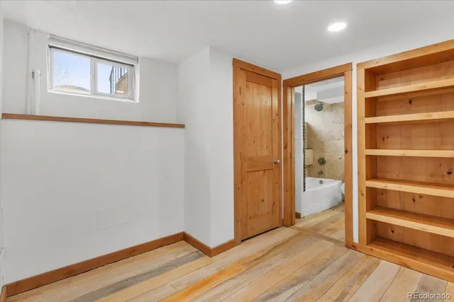 a view of an empty room and wooden floor
