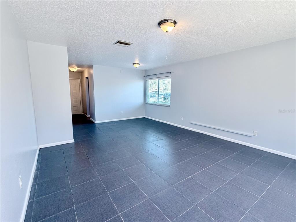 2284 Oak Neck Road, Unit F Clearwater, FL 33763 - Photo 15 of 34 an empty room with windows and entrance