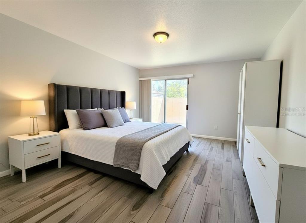 2284 Oak Neck Road, Unit F Clearwater, FL 33763 - Photo 17 of 34 a bedroom with a bed and a large window