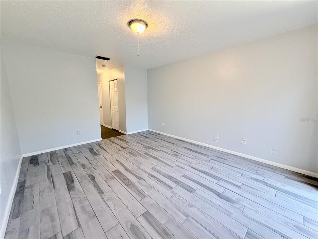 2284 Oak Neck Road, Unit F Clearwater, FL 33763 - Photo 19 of 34 a view of empty room with wooden floor and fan