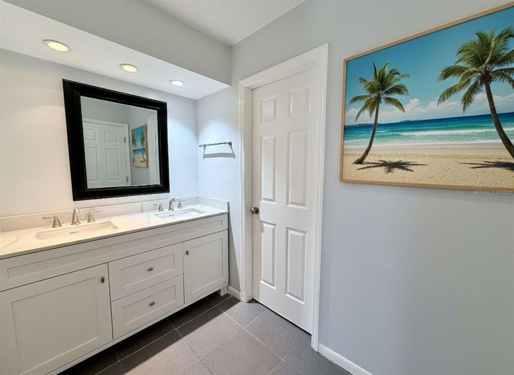 2284 Oak Neck Road, Unit F Clearwater, FL 33763 - Photo 21 of 34 a bathroom with a double vanity sink and a mirror