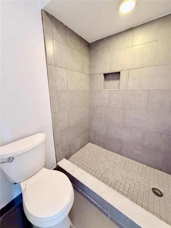 2284 Oak Neck Road, Unit F Clearwater, FL 33763 - Photo 25 of 34 a bathroom with a toilet and a shower