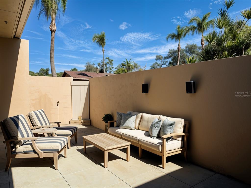 2284 Oak Neck Road, Unit F Clearwater, FL 33763 - Photo 4 of 34 an outdoor living area with furniture and a potted plant