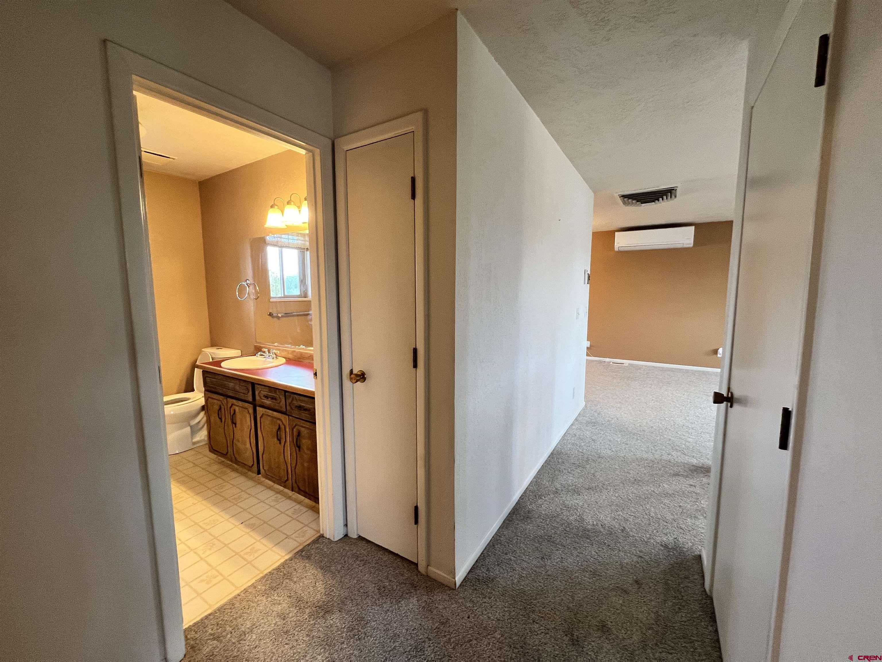1328 Jackson Street Cortez, CO 81321 - Photo 18 of 37 a view of a hallway with wooden shelves