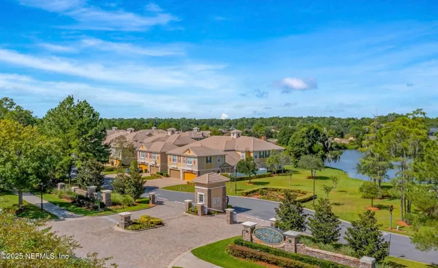 a view of a city with lawn chairs and large tree