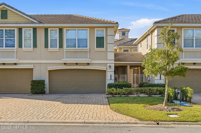 a living room with furniture a chandelier and a window