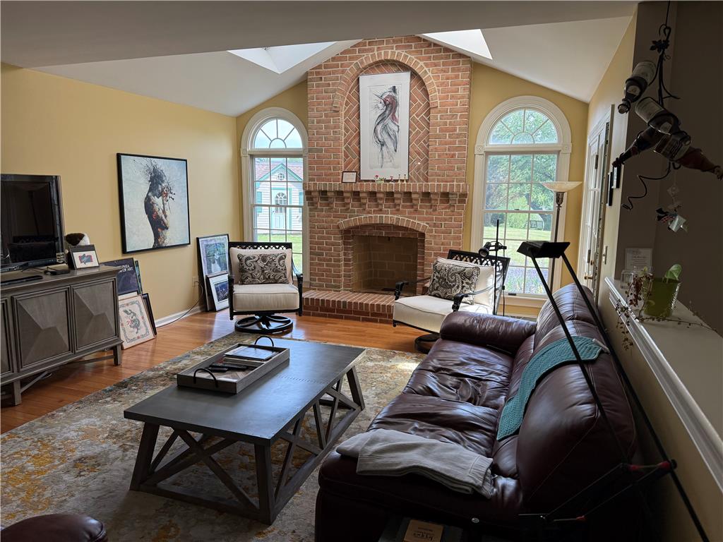 4114 Rochelle Drive Allentown, PA 18104 - Photo 12 of 35 A striking brick fireplace serves as the heart of this luminous living area, crowned by a high ceiling with skylights.