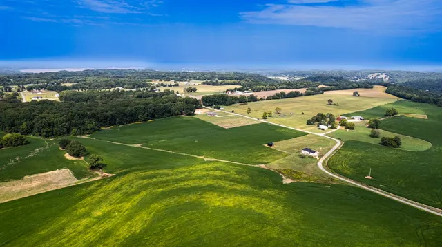 an aerial view of a houses with a yard