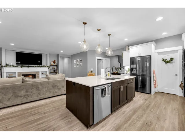 a kitchen with stainless steel appliances granite countertop a stove and a refrigerator