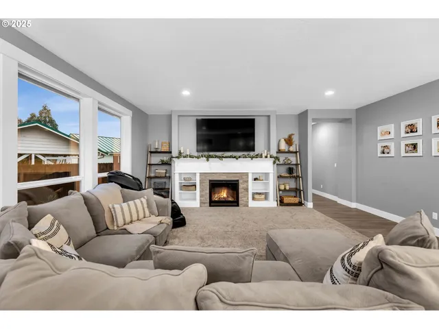 a living room with furniture a fireplace and a flat screen tv