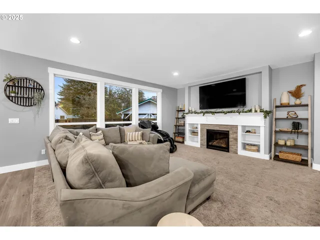 a living room with furniture a fireplace and a flat screen tv