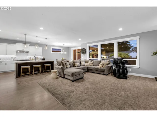 a living room with furniture and large window