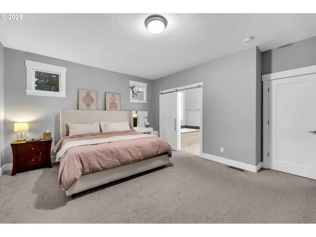 a bedroom with a bed and a night stand