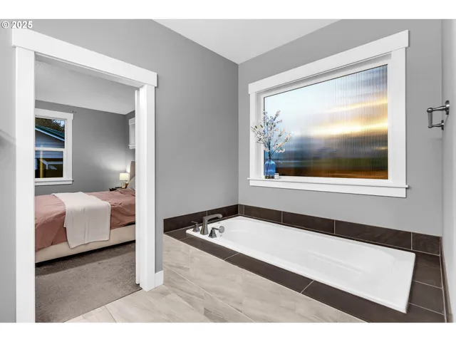 a living room with a bed and a large mirror