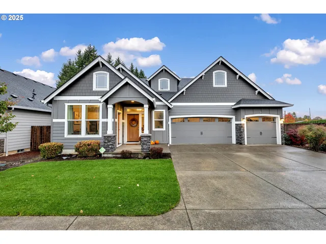 a front view of a house with a yard and garage