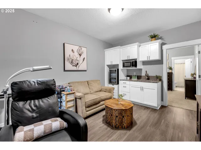 a living room with furniture and kitchen view