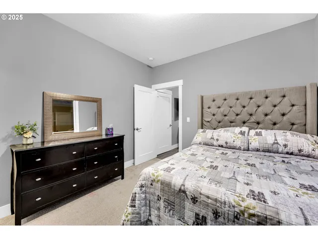 a bedroom with a bed and a dresser