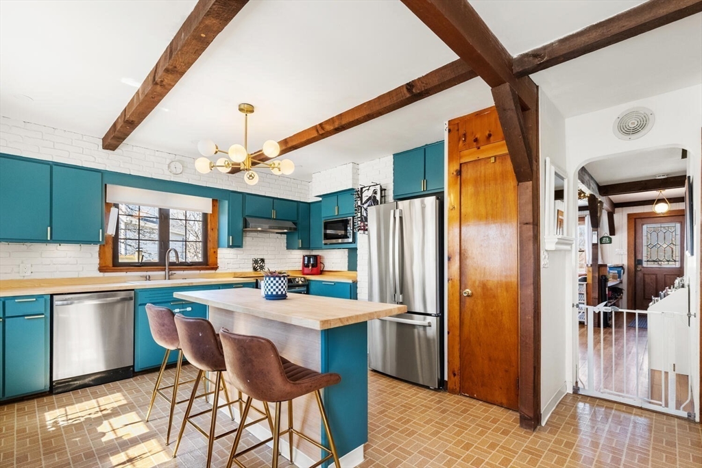 21 Gee Avenue Gloucester, MA 01930 - Photo 15 of 35 a kitchen with stainless steel appliances a refrigerator and a stove top oven