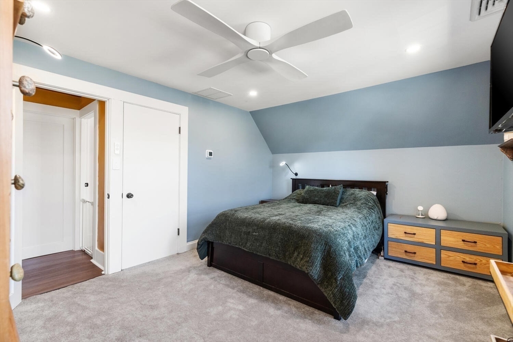 21 Gee Avenue Gloucester, MA 01930 - Photo 21 of 35 a bedroom with a bed and a chandelier