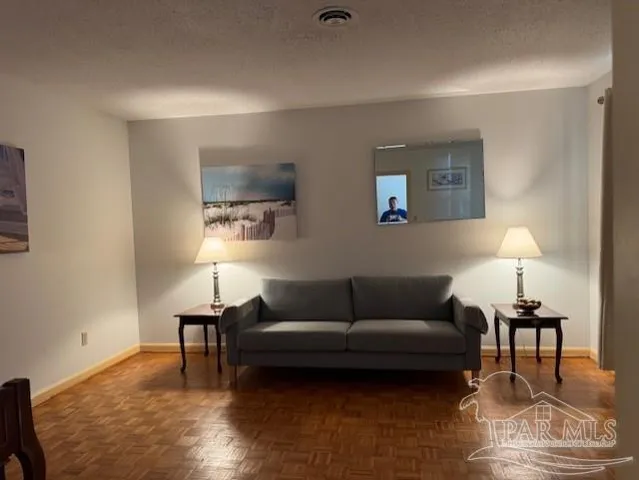 a living room with furniture and a lamp