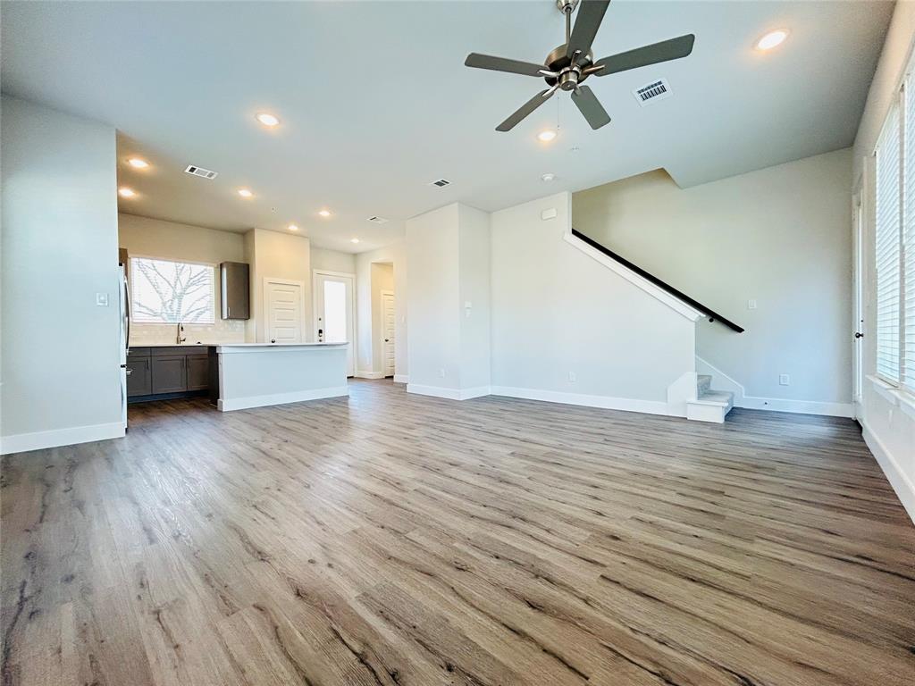 760 West Bedford Euless Road, Unit 214 Hurst, TX 76053 - Photo 25 of 32 a view of a kitchen with wooden floor and a ceiling fan