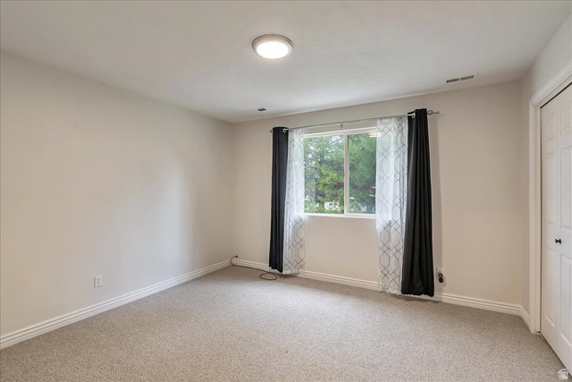 38 South 1000th Street East Payson, UT 84651 - Photo 13 of 19 Carpeted room featuring a double window, white trim, and a flush-mount ceiling light