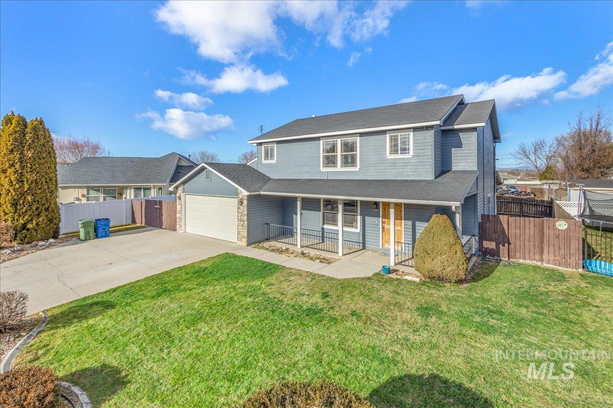 237 16th Avenue North Payette, ID 83661 - Photo 31 of 36 Traditional-style house featuring a porch, concrete driveway, an attached garage, and roof with shingles