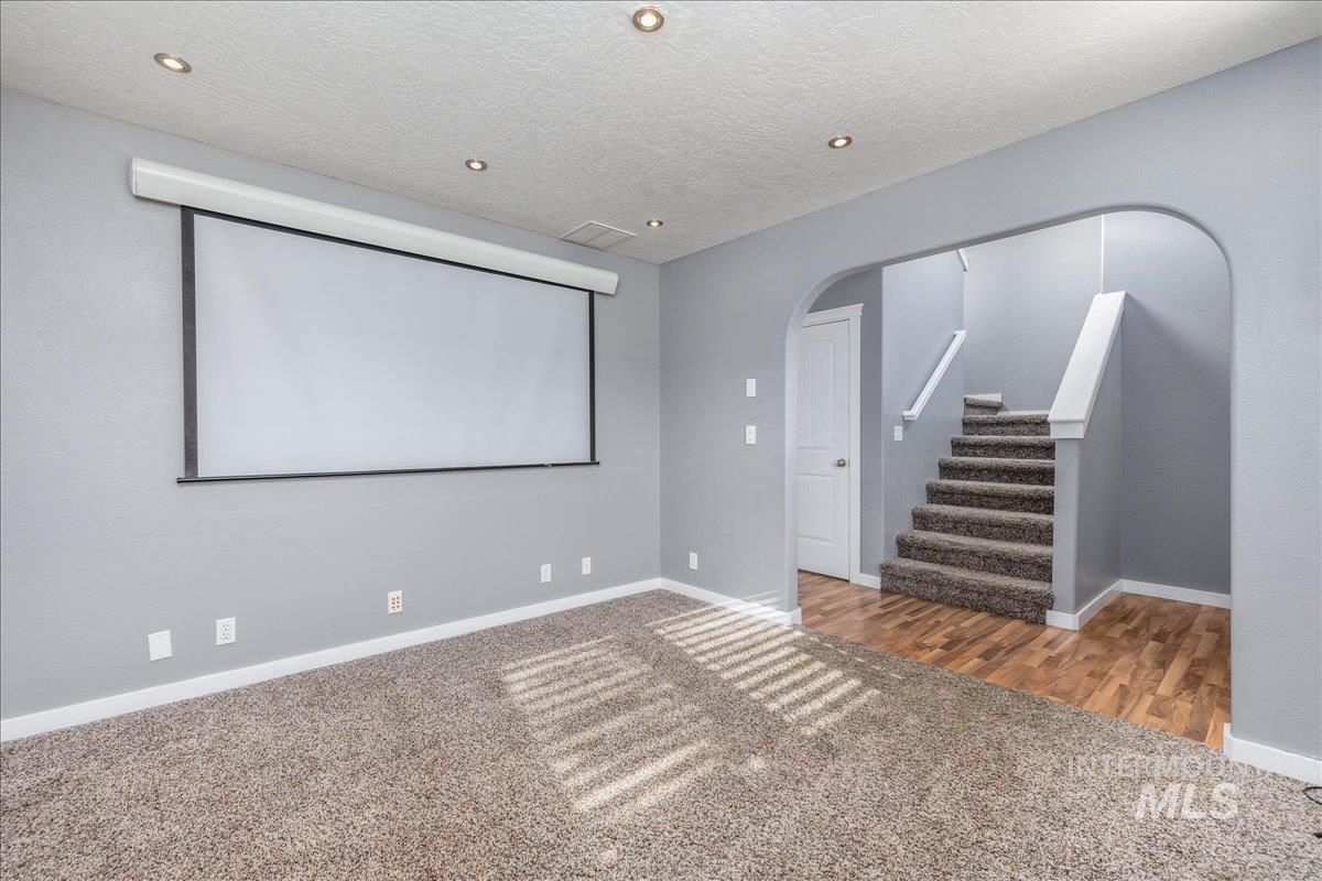 237 16th Avenue North Payette, ID 83661 - Photo 6 of 36 Carpeted home theater featuring arched walkways, a textured ceiling, and recessed lighting