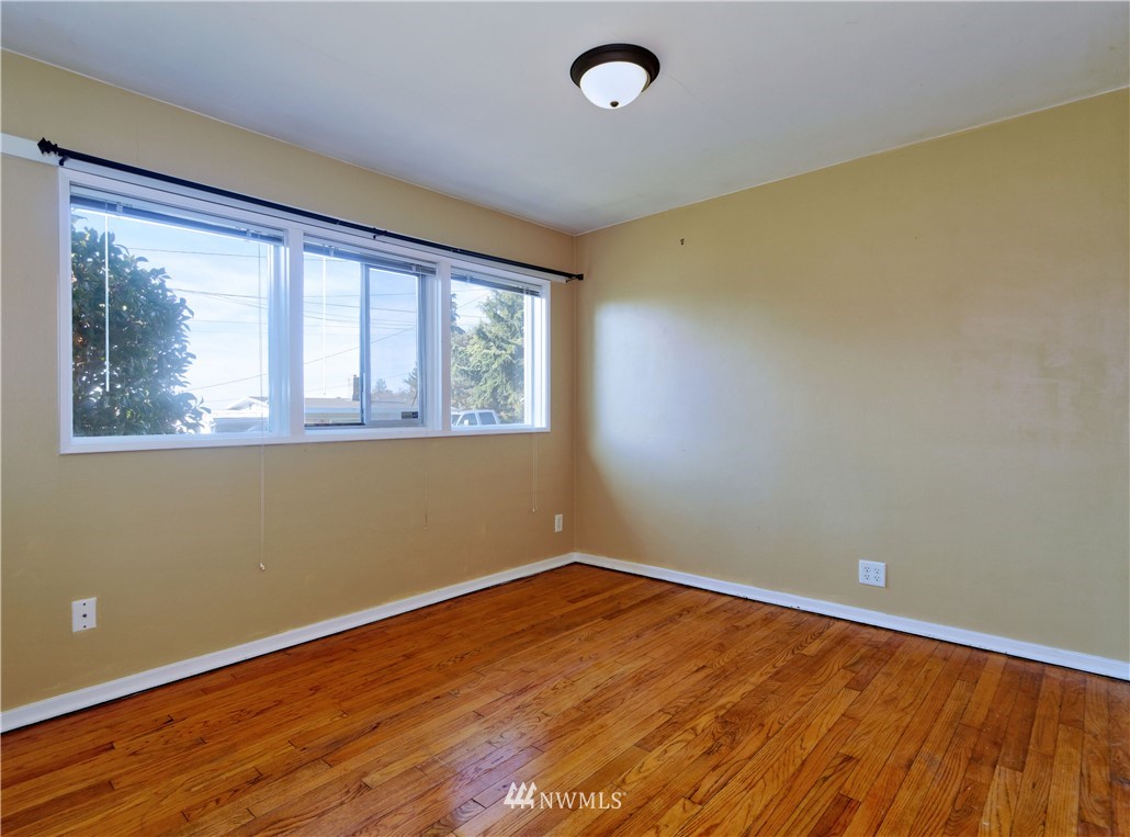 2189 Northeast 9th Place Renton, WA 98056 - Photo 15 of 21 an empty room with wooden floor and windows