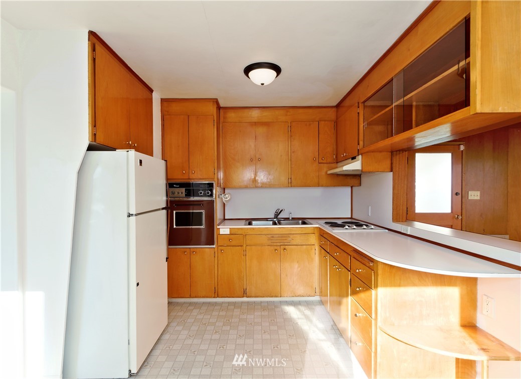 2189 Northeast 9th Place Renton, WA 98056 - Photo 6 of 21 a kitchen with stainless steel appliances granite countertop a refrigerator and a sink