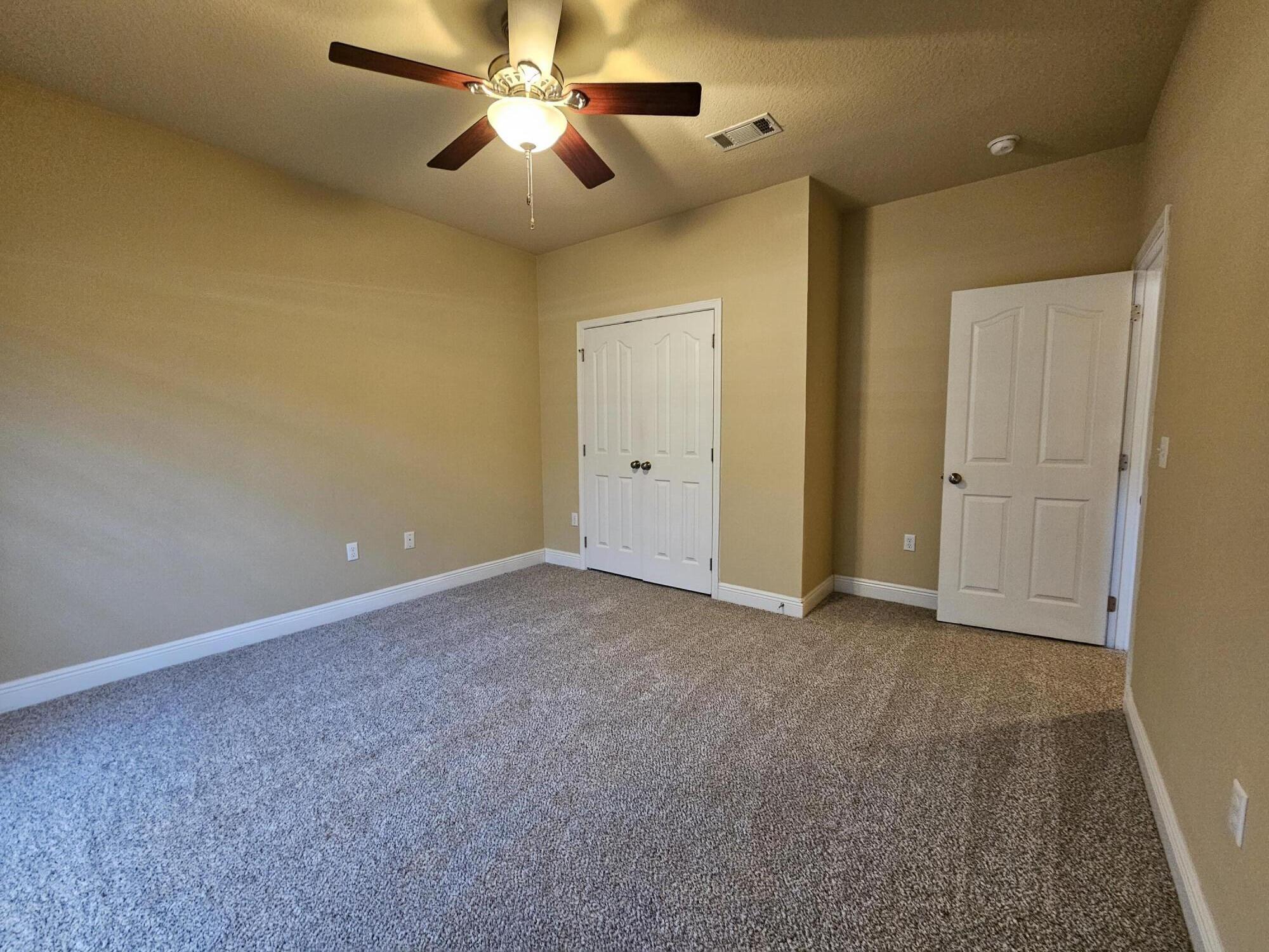 660 Red Fern Road Crestview, FL 32536 - Photo 16 of 22 an empty room with closet and a chandelier fan