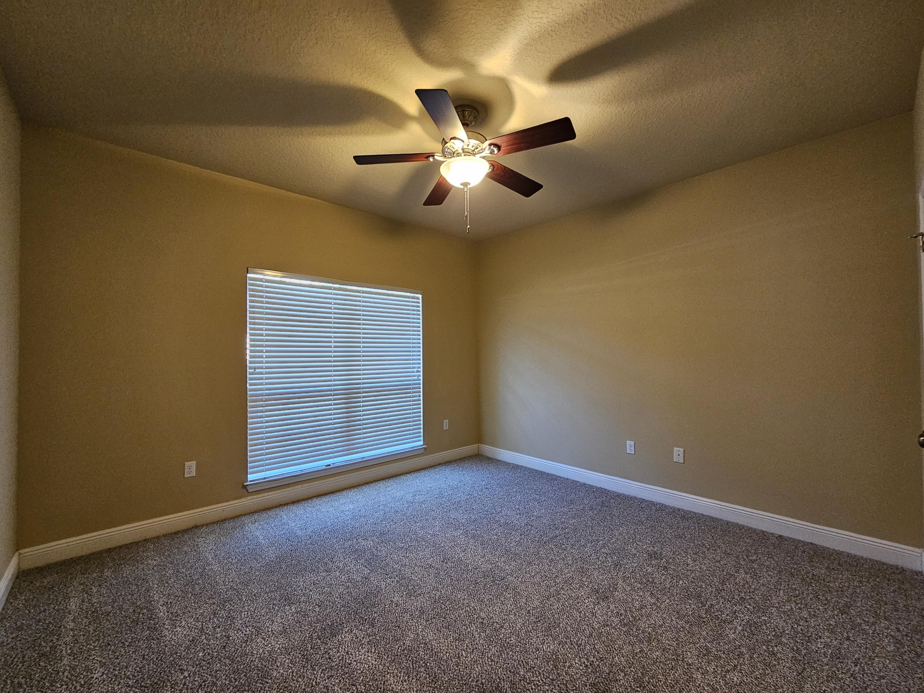 660 Red Fern Road Crestview, FL 32536 - Photo 17 of 22 a view of an empty room with a ceiling fan and a window