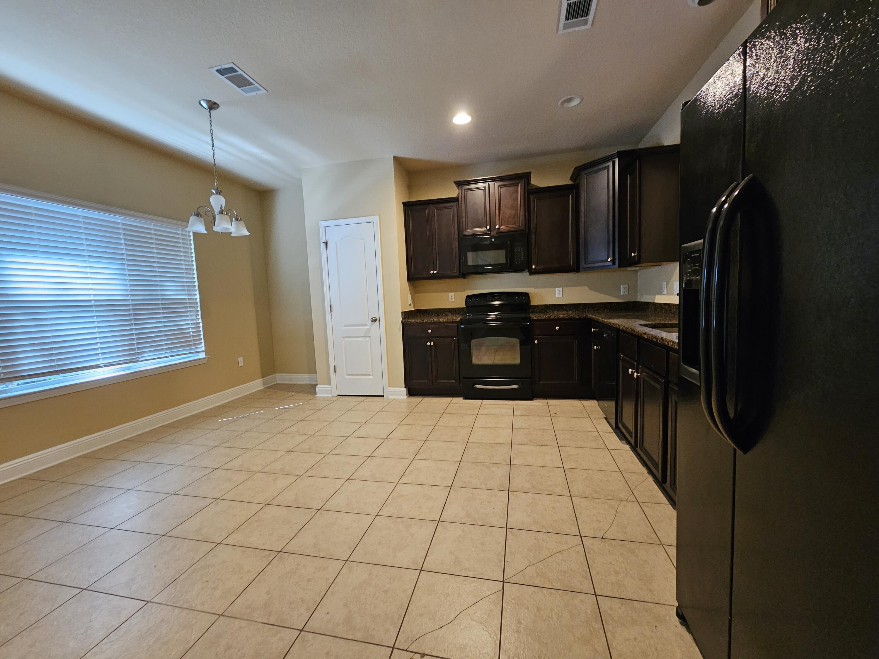 660 Red Fern Road Crestview, FL 32536 - Photo 6 of 22 a kitchen with stainless steel appliances a refrigerator and a sink