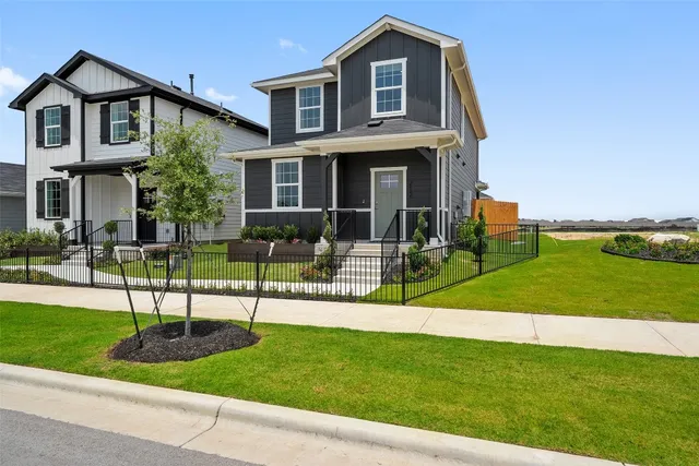 a view of house with a yard