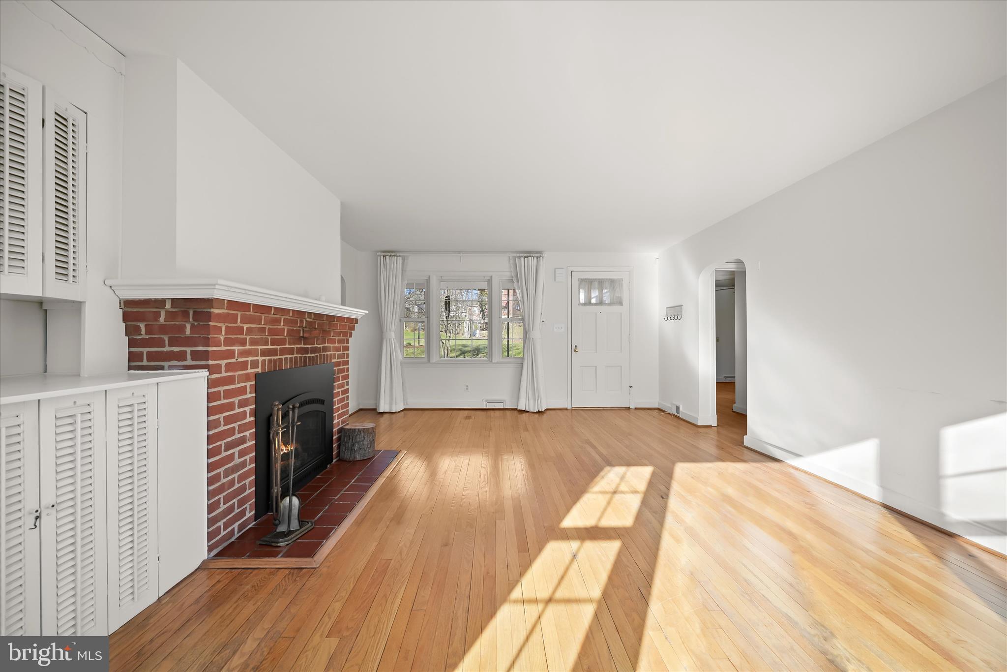 3637 Sussex Road Pikesville, MD 21207 - Photo 11 of 33 a view of empty room with fireplace and wooden floor