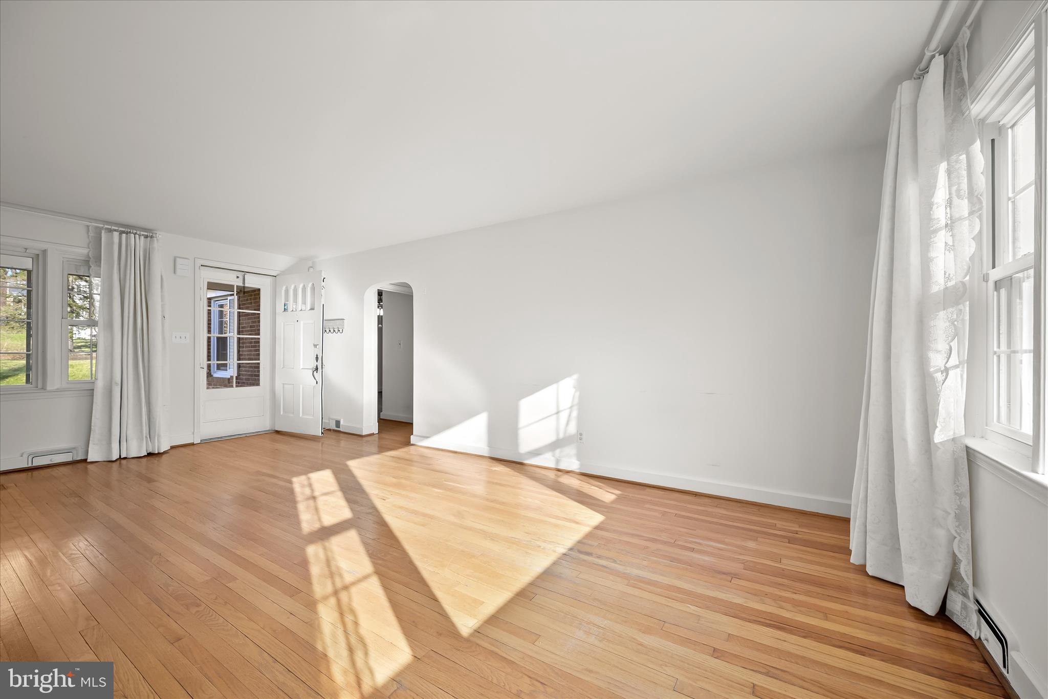 3637 Sussex Road Pikesville, MD 21207 - Photo 12 of 33 a view of an empty room with wooden floor and a window