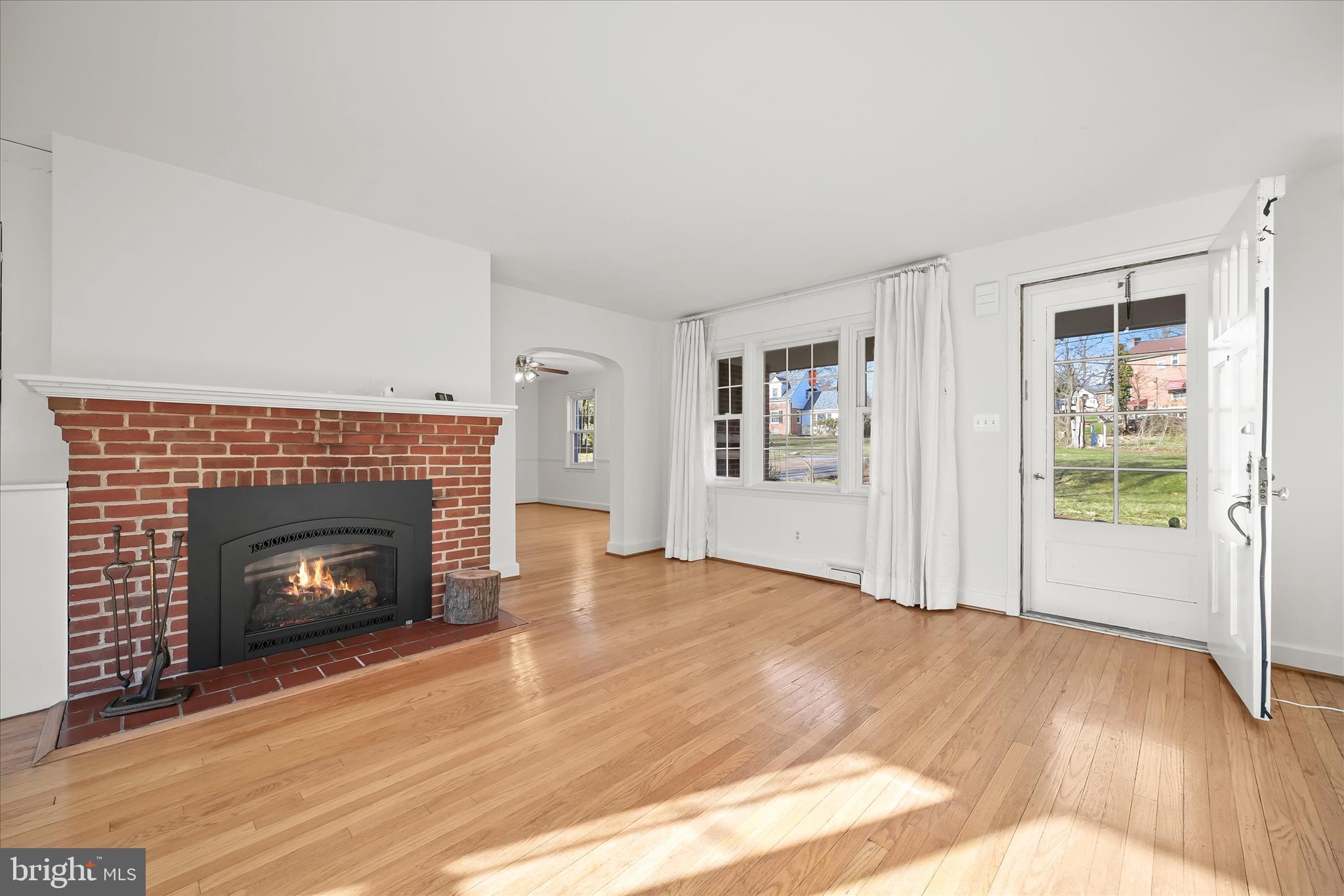 3637 Sussex Road Pikesville, MD 21207 - Photo 13 of 33 a view of an empty room with wooden floor fireplace and a window