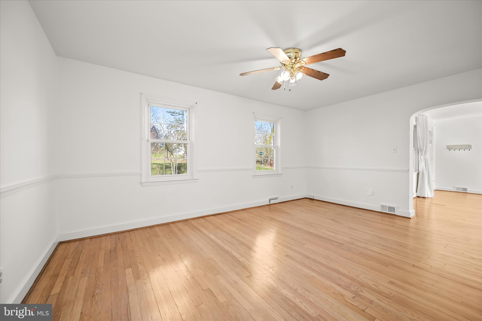 3637 Sussex Road Pikesville, MD 21207 - Photo 14 of 33 wooden floor in an empty room with a window