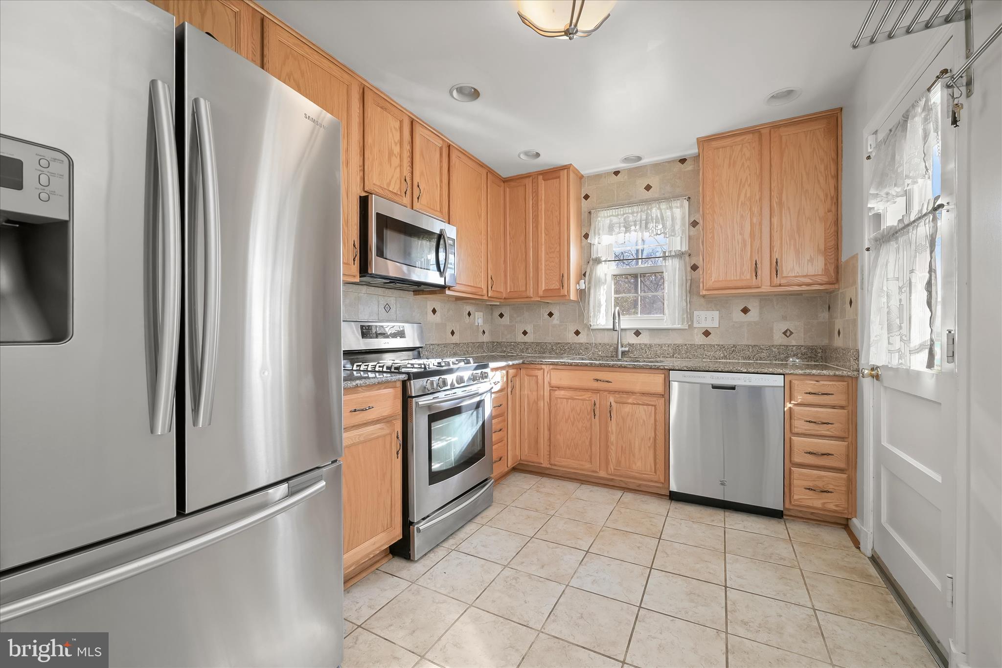 3637 Sussex Road Pikesville, MD 21207 - Photo 16 of 33 a kitchen with a stove sink and refrigerator
