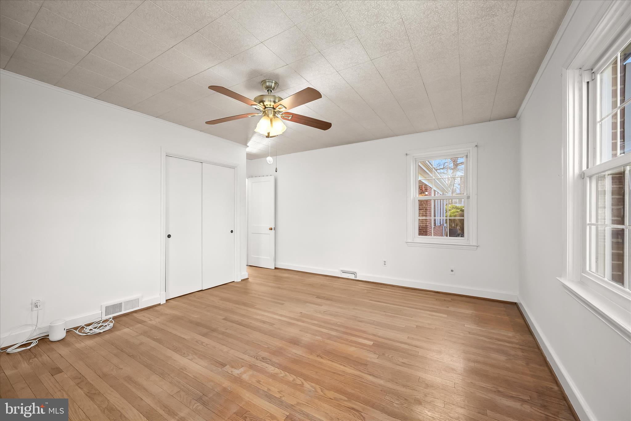 3637 Sussex Road Pikesville, MD 21207 - Photo 21 of 33 an empty room with wooden floor and windows