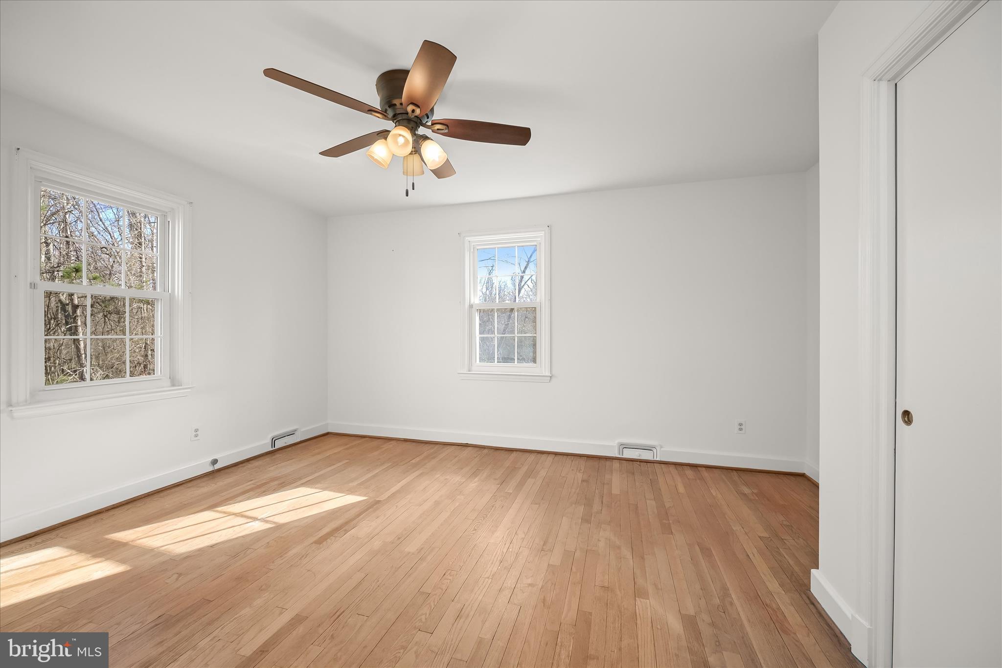 3637 Sussex Road Pikesville, MD 21207 - Photo 23 of 33 wooden floor in an empty room with a window