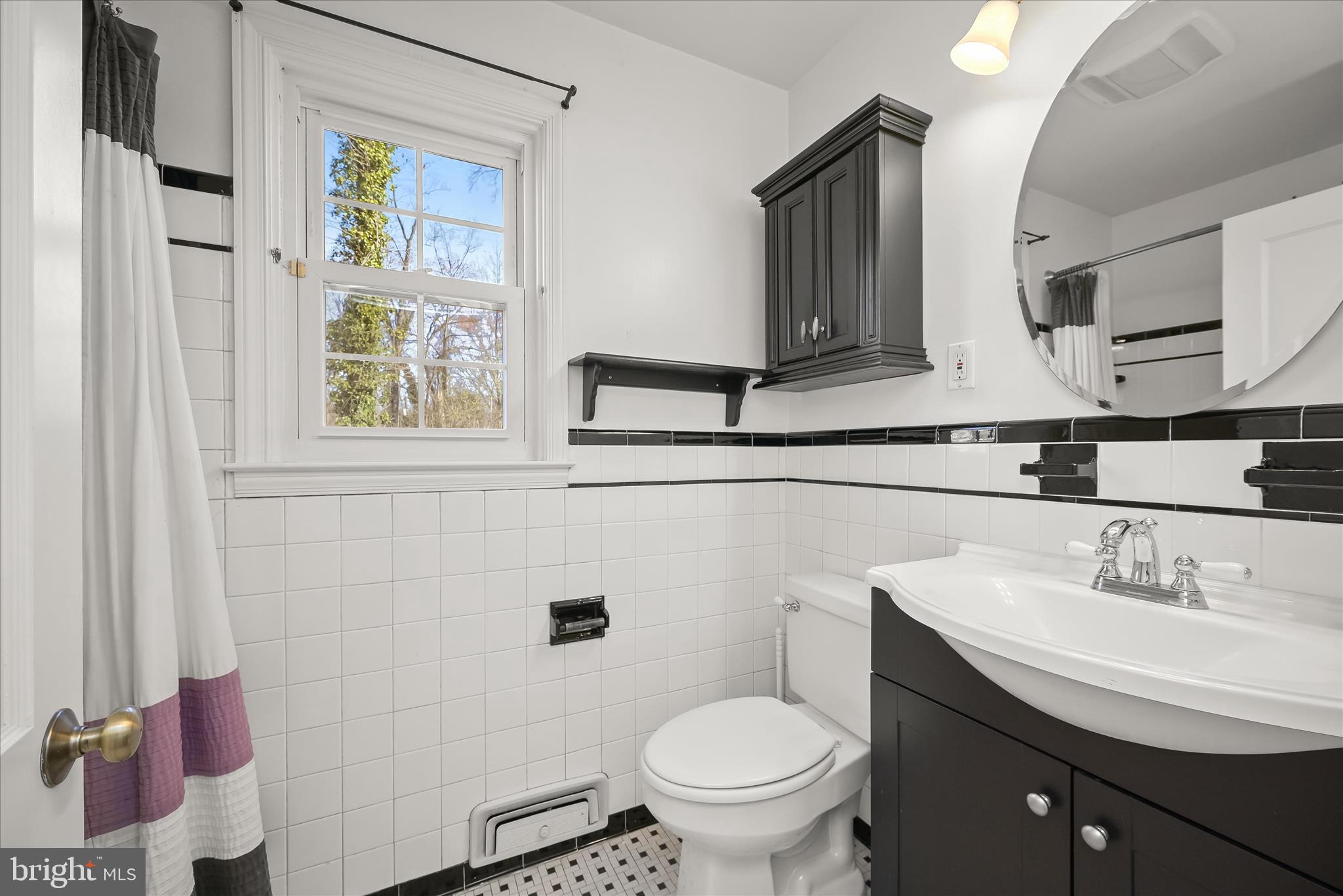 3637 Sussex Road Pikesville, MD 21207 - Photo 27 of 33 a bathroom with a toilet sink and mirror