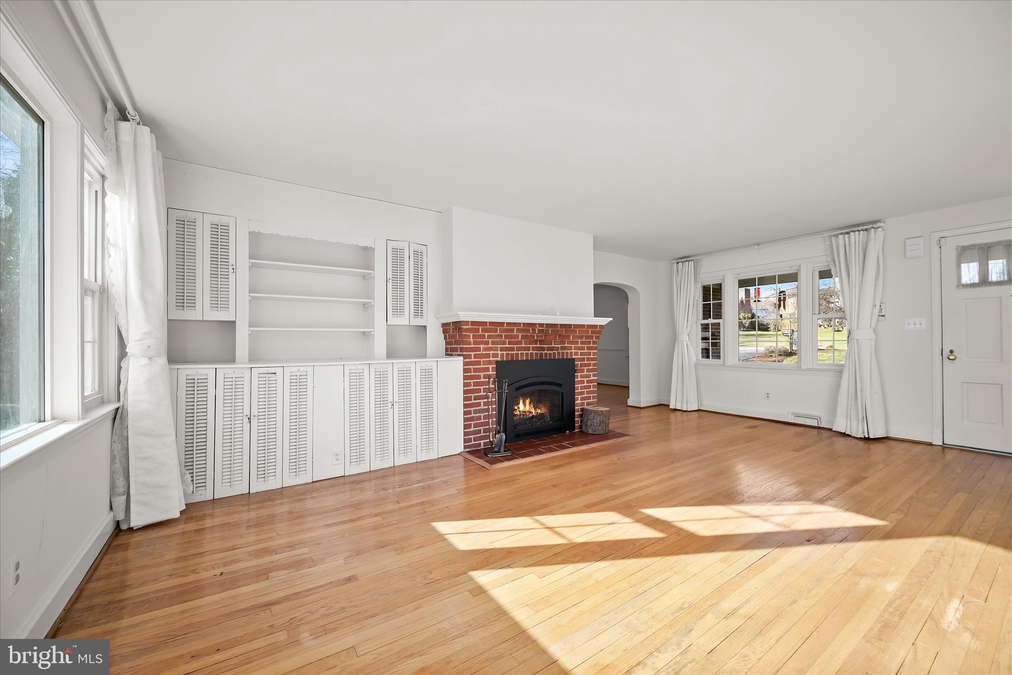 3637 Sussex Road Pikesville, MD 21207 - Photo 7 of 33 a view of a livingroom with a fireplace wooden floor and window