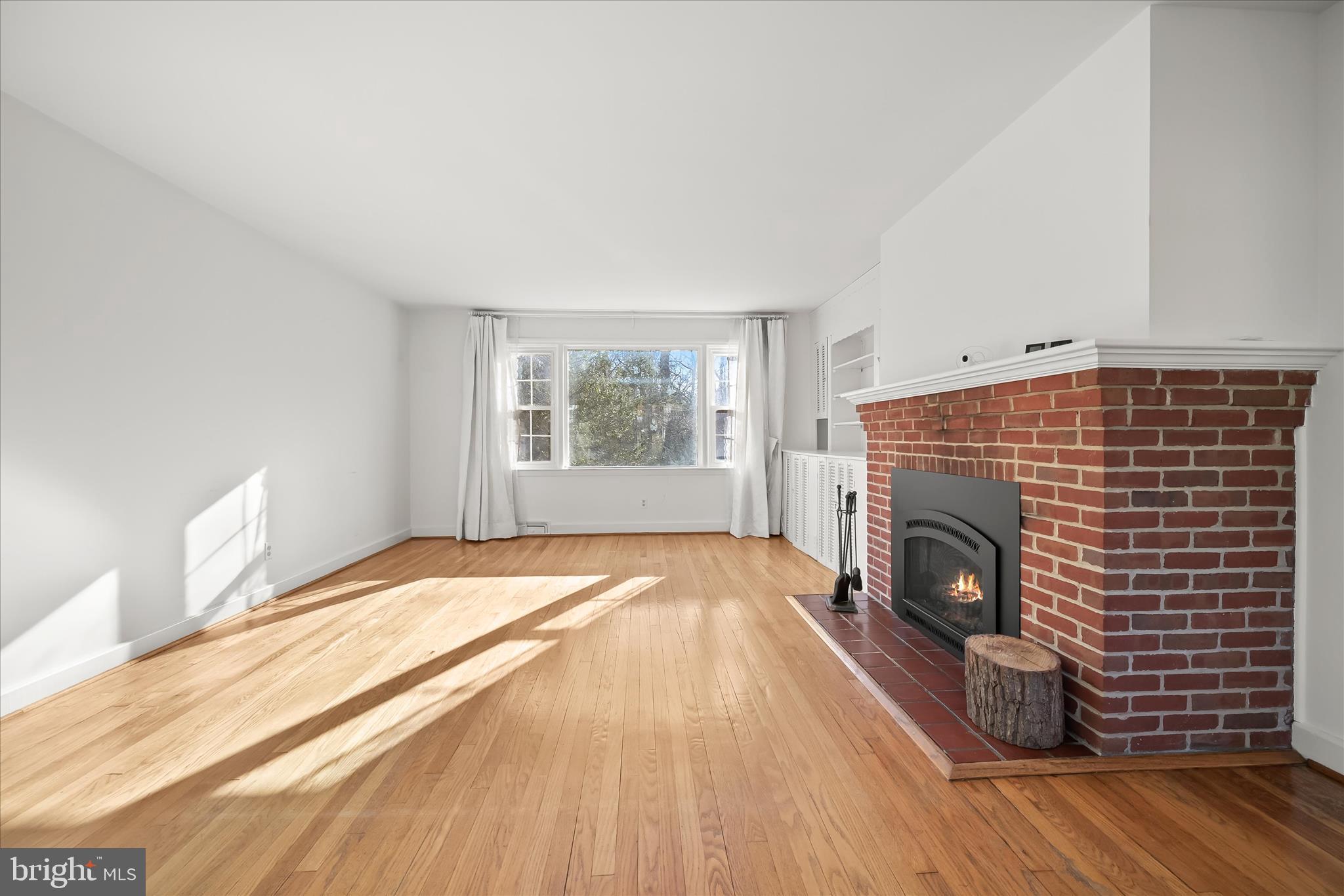 3637 Sussex Road Pikesville, MD 21207 - Photo 8 of 33 a view of empty room with wooden floor and fireplace