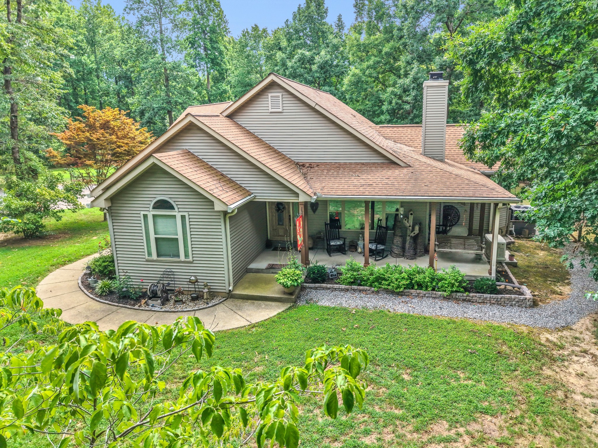 a view of a house with a yard and potted plants