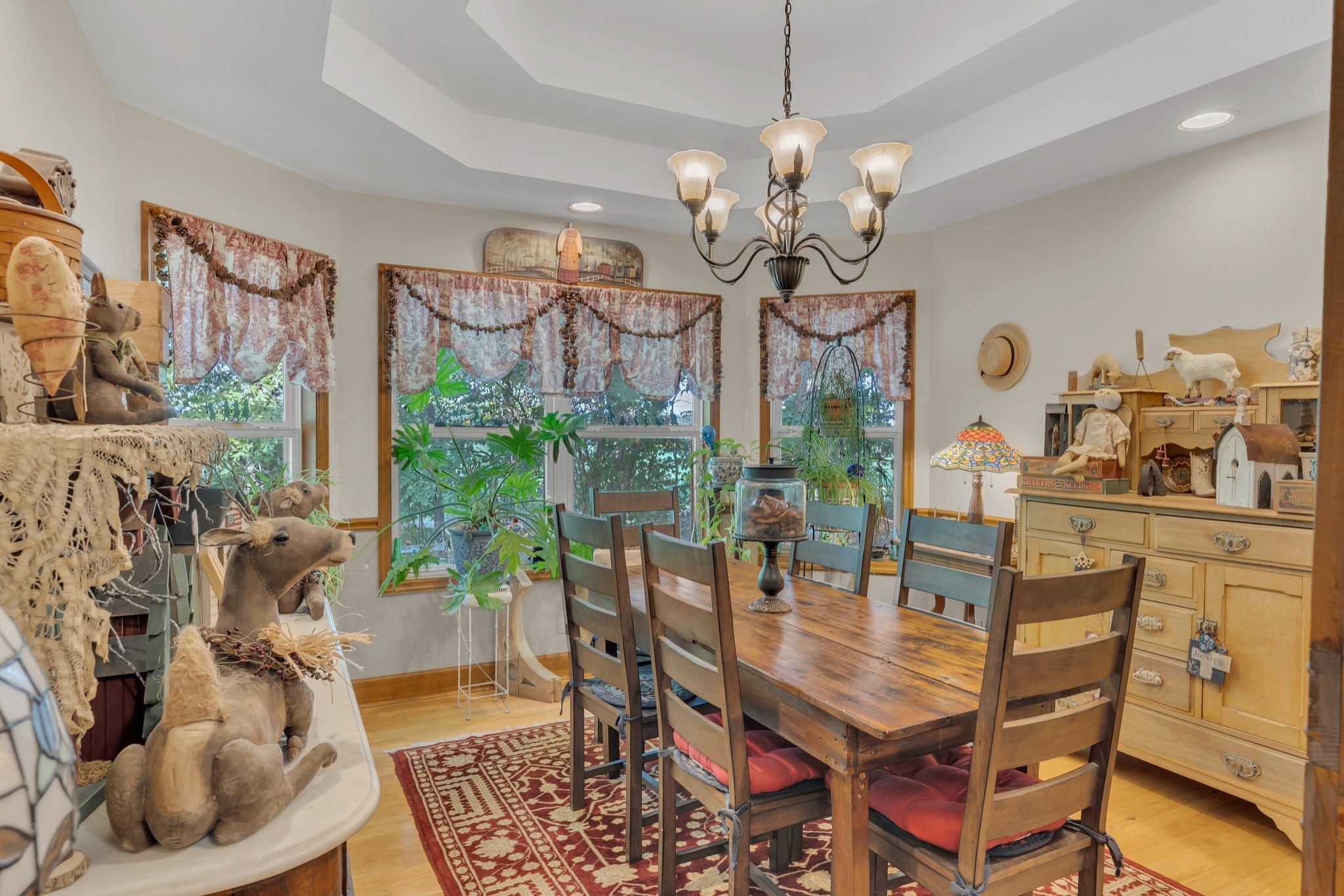 7197 Highland Road Portland, TN 37148 - Photo 14 of 92 a dining room with wooden floor a chandelier a wooden table and chairs